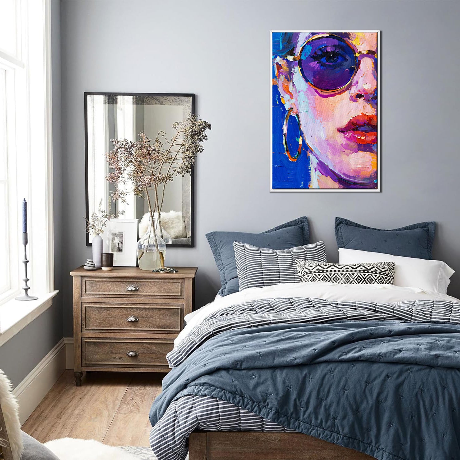 white frame wall art painting depicts woman wearing round sunglasses and large hoop earrings