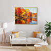 gold frame wall art painting of an autumn lakeside hangs on a simple and bright interior wall