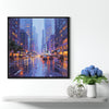 a black frame wall art painting showing the bustling city streets on a rainy night hangs on the wall of a warmly decorated room