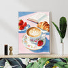 white frame wall art canvas painting depicts a cozy scene with latte art coffee, strawberries, croissants and an open book.