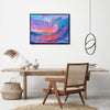 black frame wall art painting above the table depicts the magnificent scene of colorful waves surging.