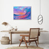 white frame wall art painting above the table depicts the magnificent scene of colorful waves surging.