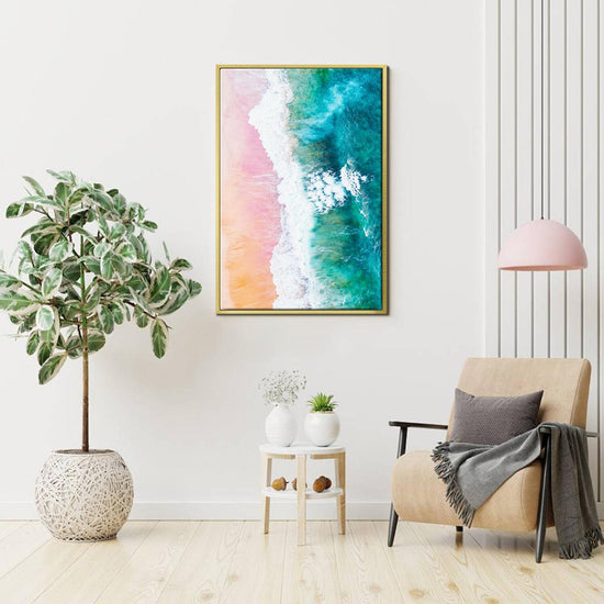 gold frame wall art canvas depicts pink sand beach and white waves